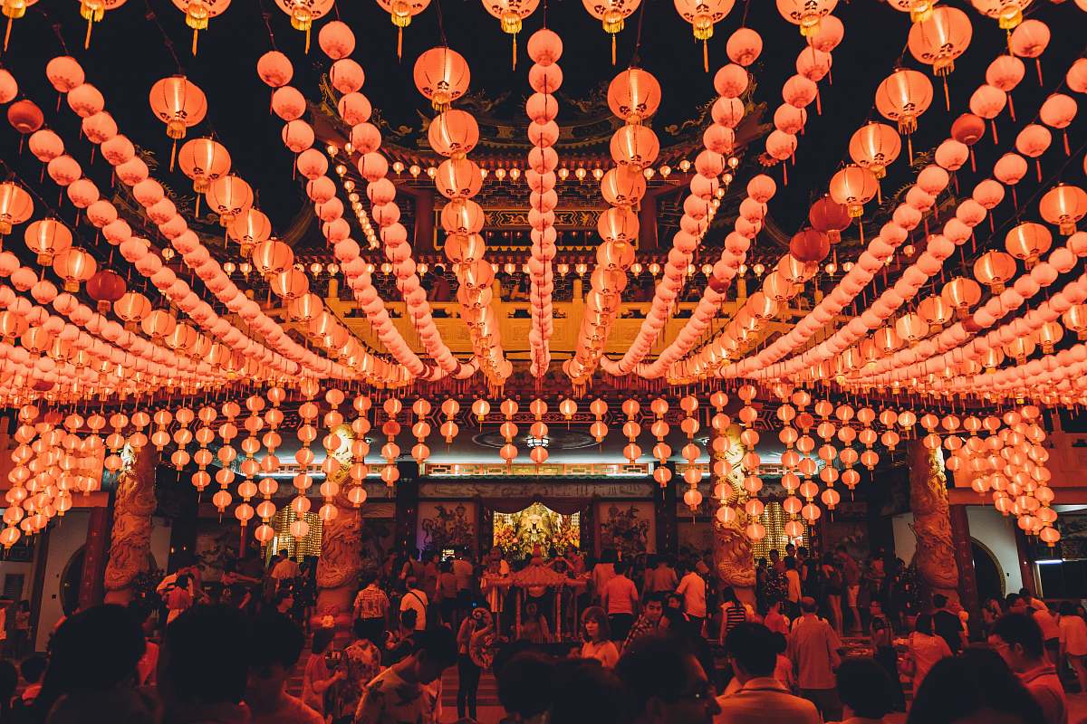 pub people gathering under orange paper lanterns glow